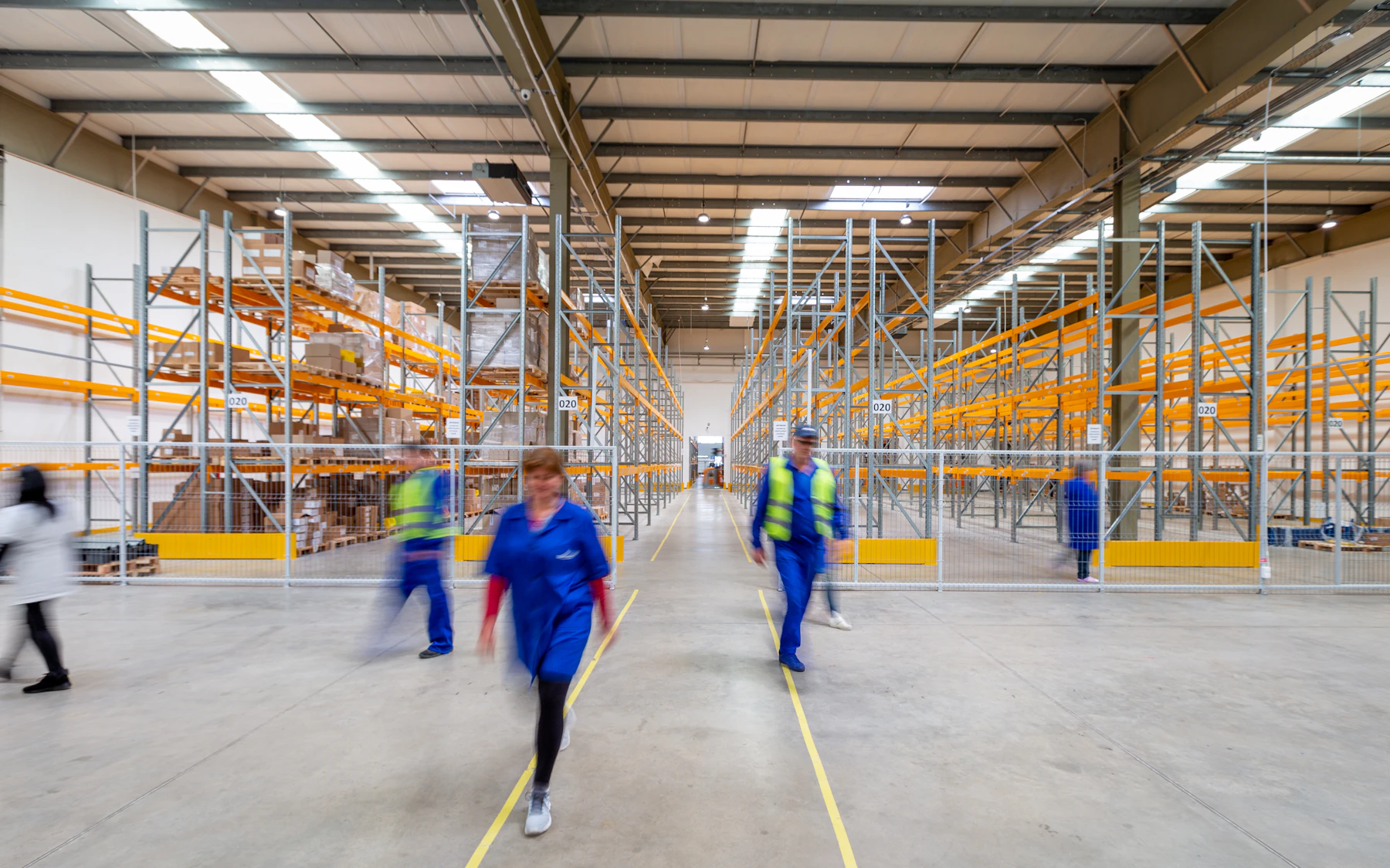 Operations team moving through a large logistics warehouse